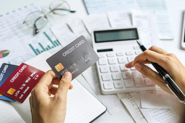 Stressed young woman calculating monthly home expenses, taxes, bank account balance and credit card bills payment, Income is not enough for expenses 