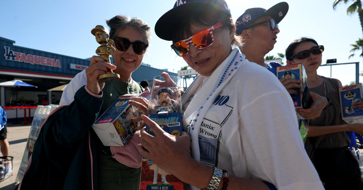 Hundreds of Dodgers fans line up hours before the game starts to get their hands on a bobblehead of Shohei Ohtani