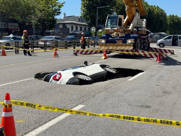 Sinkhole swallows SUV on road in South Korean capital Seoul, injuring 2 occupants