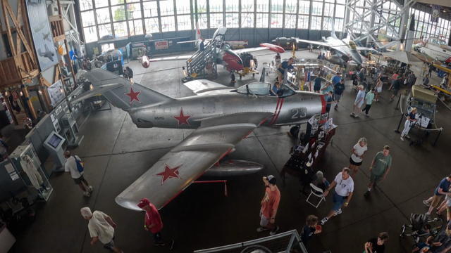 An overhead view of the museum, including visitors and a plane 