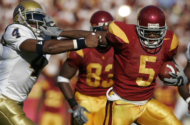 USC's Reggie Bush grabs the facemask of UCLA Bruin Jarrad Page in USC's 66–19 win at the LA Coliseu 