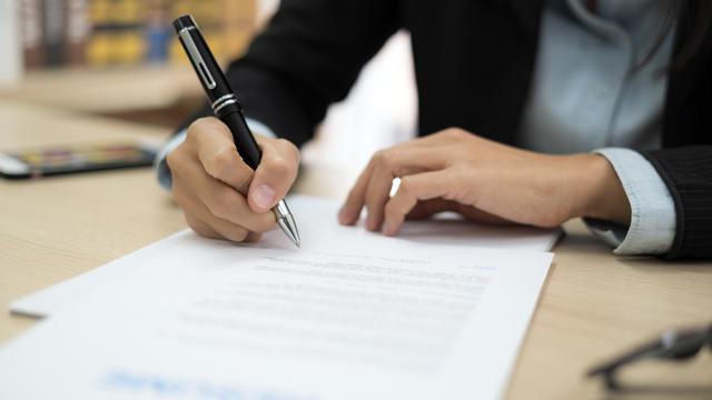 Woman signing job contract 