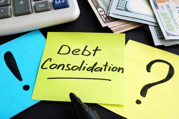 Debt consolidation written by hand and money. 