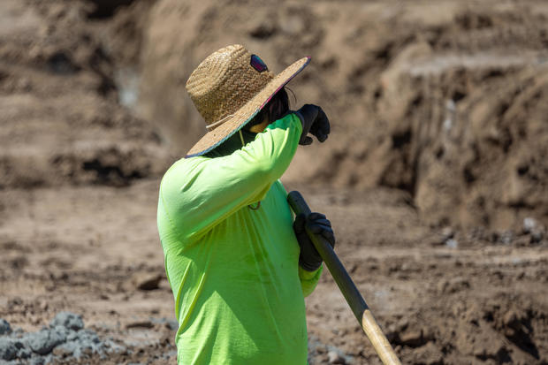 Construction workers work amidst a heat wave in Irvine 