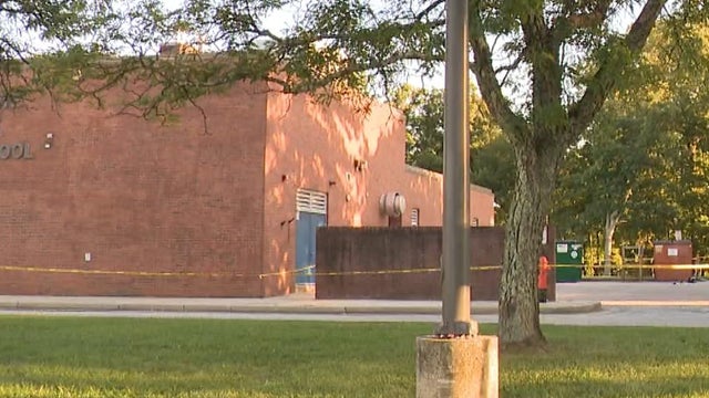 the concept of arrest and crime. handcuffs on a wooden table 