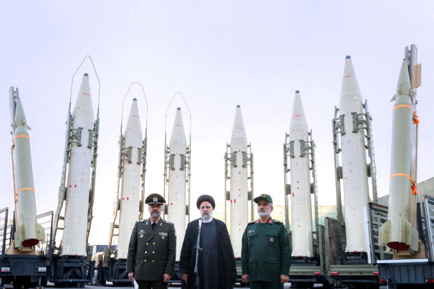 Then-Iranian President Ebrahim Raisi, center, speaks during a ceremony announcing new ballistic missiles for the Armed Forces of Iran, in a file photo taken in Tehran