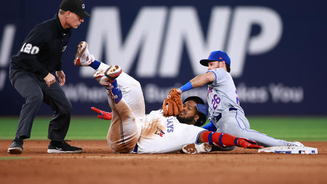 Vladimir Guerrero Jr. #27 of the Toronto Blue Jays collides with Eddy Alvarez #26 of the New York Mets at second base and is called out after video replay in the sixth inning during a game at Rogers Centre on September 10, 2024 in Toronto, Ontario, Canada. 