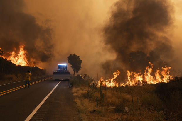 A Cal Fire bulldozer retreats as there Airport Fire 