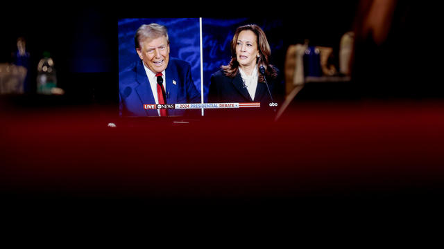 Former President Donald Trump and Vice President Kamala Harris are shown on screen in the spin room during the second presidential debate at the Pennsylvania Convention Center in Philadelphia, Pennsylvania, US, on Tuesday, Sept. 10, 2024. 