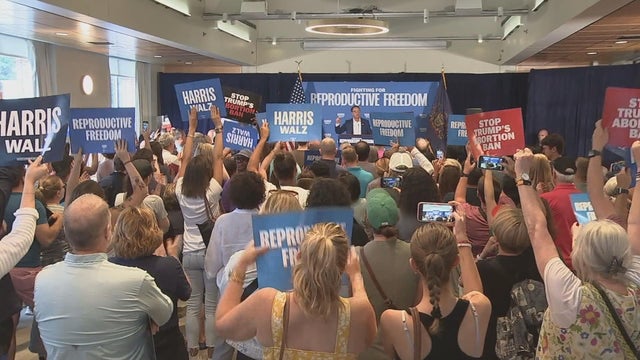 Supporters hold up signs that say HARRIS - WALZ while Pennsylvania Gov. Josh Shapiro speaks