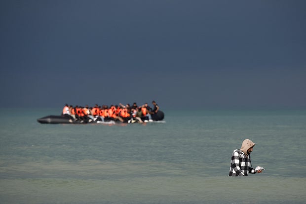 Migrants attempt to cross the English Channel, on the beach of the Slack dunes in Wimereux