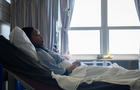 Sick patient lying in hospital bed 