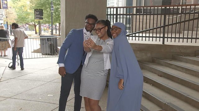 Three people pose for a selfie 