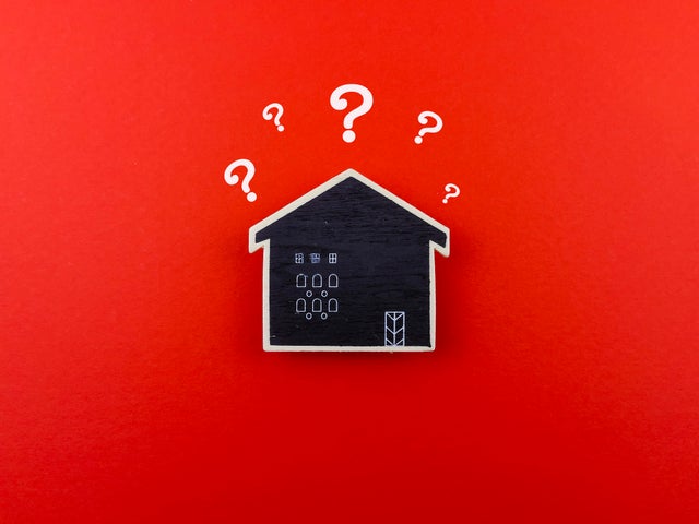 Wooden House Replica With Question Mark,  Business property and real estate concepts 