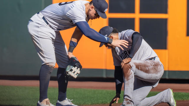 Centerfielder Aaron Judge #99 of the New Yankees checks on right fielder Juan Soto #22 who collided with the wall in the seventh inning at T-Mobile Park on September 19, 2024 in Seattle, Washington. 