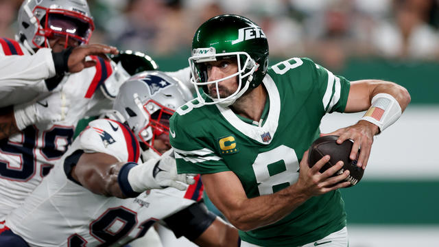 Aaron Rodgers #8 of the New York Jets scrambles against the New England Patriots during the second quarter in the game at MetLife Stadium on September 19, 2024 in East Rutherford, New Jersey. 