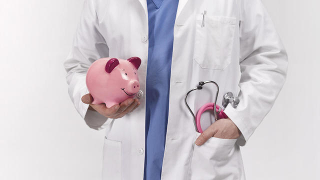 Doctor with piggy bank 