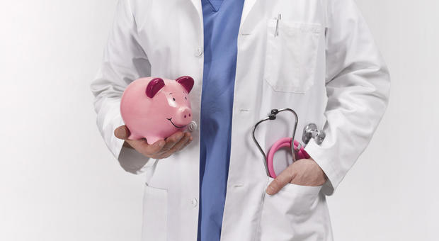 Doctor with piggy bank 