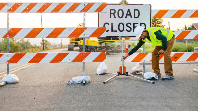 Hispanic Workers Setting Barriers and Directing Traffic Street Road and Highway Construction Photo Series 