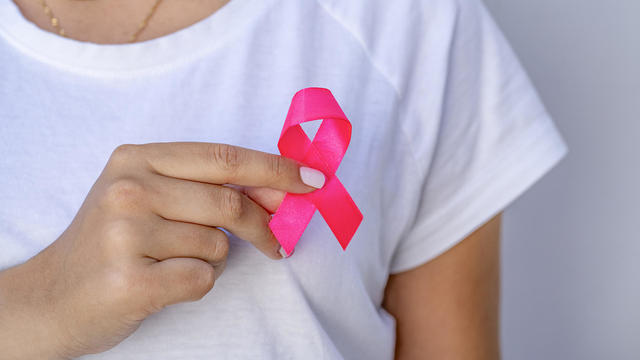 Young woman with pink ribbon 