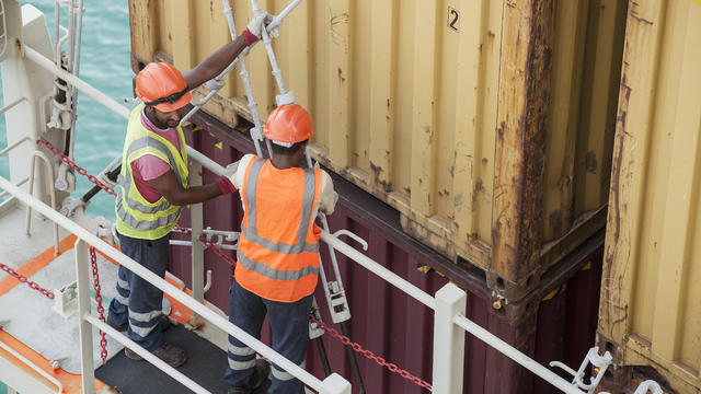 Workers on container ship 