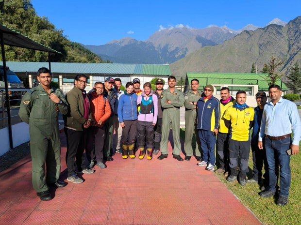 Rescued British and U.S. climbers pose for a photo with rescuers in Joshimath, Uttarakhand