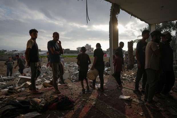 Palestinians examine a destroyed mosque following an Israeli airstrike in Deir al-Balah, Sunday