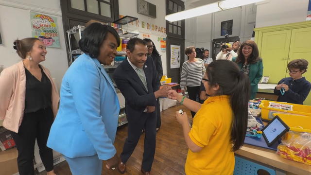 Mayor Cherelle Parker smiles as a student fist bumps with Superintendent Tony Watlington 