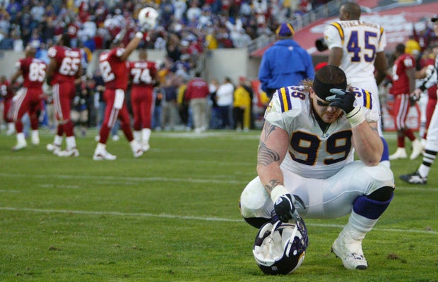 Tempe Arizona, Sun Devil Stadium 12/28/03 Minnesota Vikings vs Arizona Cardinals---- A dejected Chris Hovan neels on the turf after the Vikings loss 18-17 in the last seconds of the game during Sunday afternoon game at Sun Devil Stadium.
