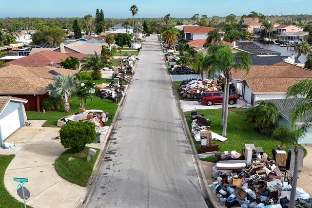 Debris from homes flooded by Hurricane Helene sits curbside as Hurricane Milton approaches on Oct. 8, 2024, in Port Richey, Florida. 