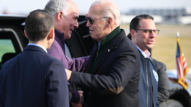 Sen. Bob Casey and President Joe Biden stand at a lectern together 