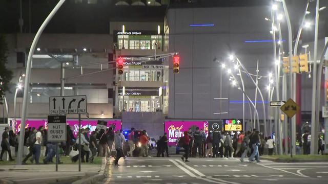 Crowds of people leaving the American Dream mall, directed by New Jersey State Police. 