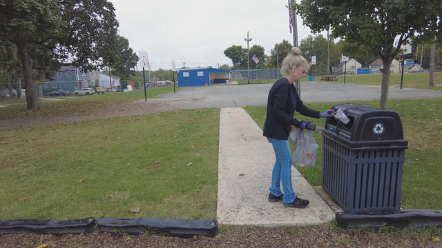 Christina Koronkiewicz puts trash in a trash can at a park in Delaware County 