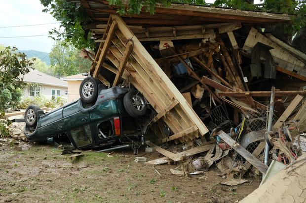 A damaged car sits under a destroyed shed after flooding caused by Hurricane Helene in Swannanoa, North Carolina, on Oct. 3, 2024. 