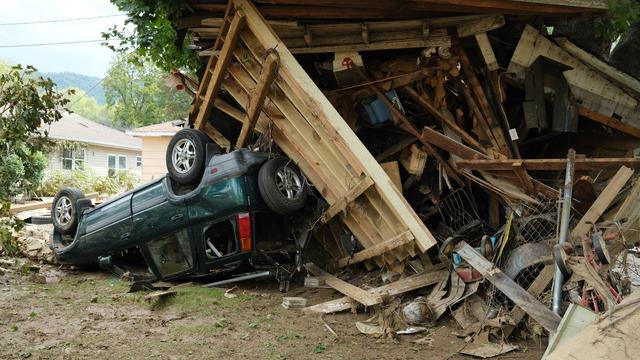 A damaged car sits under a destroyed shed after flooding caused by Hurricane Helene in Swannanoa, North Carolina, on Oct. 3, 2024. 