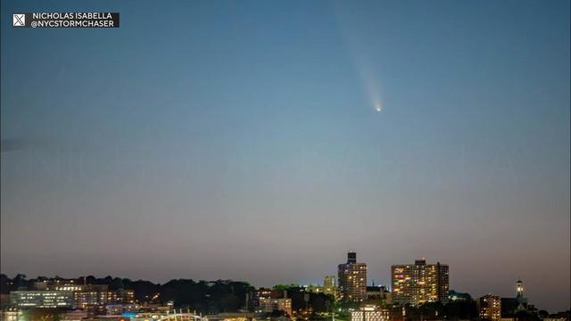 A comet streaks through the sky above the Staten Island skyline. 