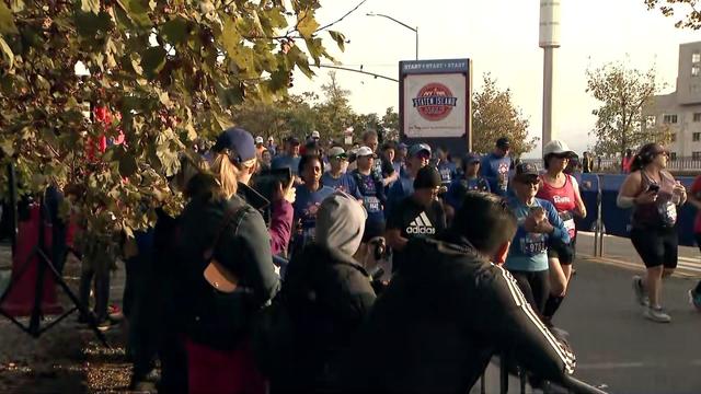 Marathon runners running on city road 