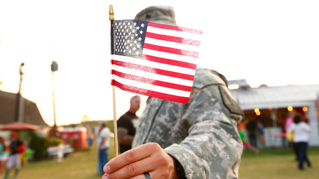 Veteran with American flag in military uniform 