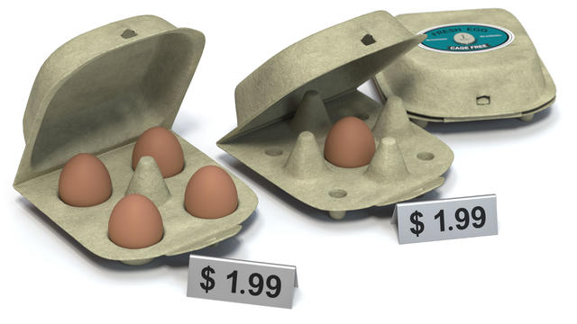 Five brown eggs instead of six in an open egg carton on orange background. Shrinkflation concept. 