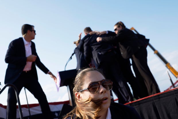 Former President Donald Trump is rushed offstage by U.S. Secret Service agents after being grazed by a bullet during a rally on July 13, 2024, in Butler, Pennsylvania.