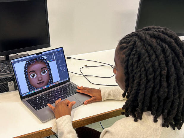 Designer Vanita Brown looks at the final version of one of the Afro hair emojis at the Concorde Youth Club in Hackney, east London 