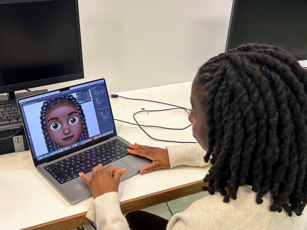 Designer Vanita Brown looks at the final version of one of the Afro hair emojis at the Concorde Youth Club in Hackney, east London