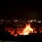 Israeli forces attack targets around Beirut while Hezbollah fires rockets into Israel