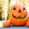 Jack-O-Lantern and three small pumpkins 