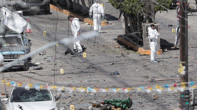 Federal forces work the scene of a car bomb in Jerecuaro 