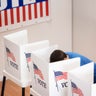 Caucasian voter voting in polling place 