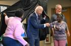 President Biden is handed an I Voted sticker as he steps out of the voting booth after casting his early voting ballot in the 2024 general election in New Castle, Delaware, on Oct. 28, 2024. 