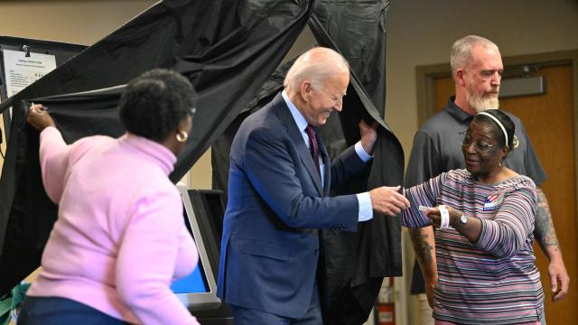 President Biden is handed an I Voted sticker as he steps out of the voting booth after casting his early voting ballot in the 2024 general election in New Castle, Delaware, on Oct. 28, 2024. 