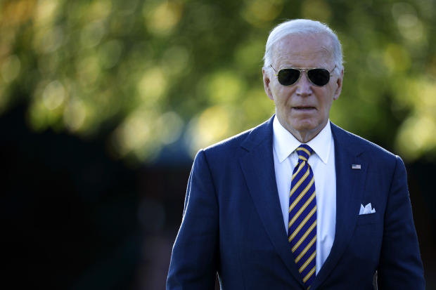 President Biden talks briefly with reporters as he departs the White House on Oct. 24, 2024, in Washington. 