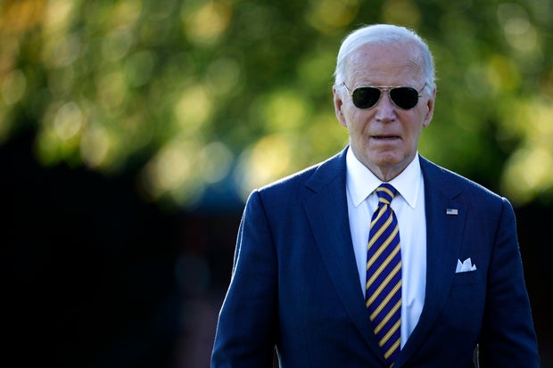 President Biden talks briefly with reporters as he departs the White House on Oct. 24, 2024, in Washington.